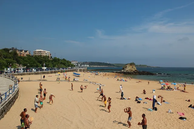 Dos jugadores devuelven una pelota con palas de madera en la playa